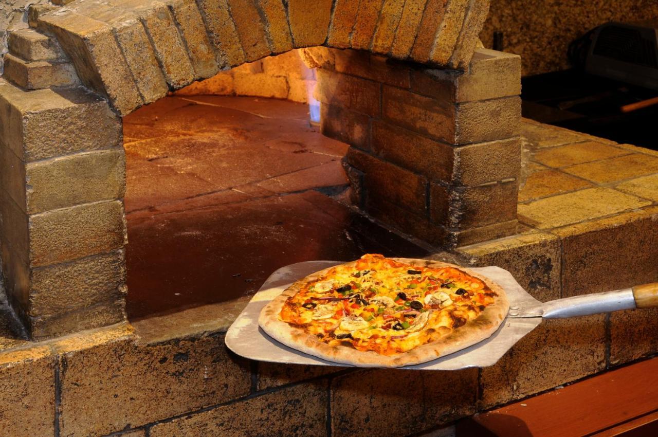 Belair Unique Mexico City Wtc, Trademark By Wyndham Exterior photo Pizza being removed from a wood-fired oven